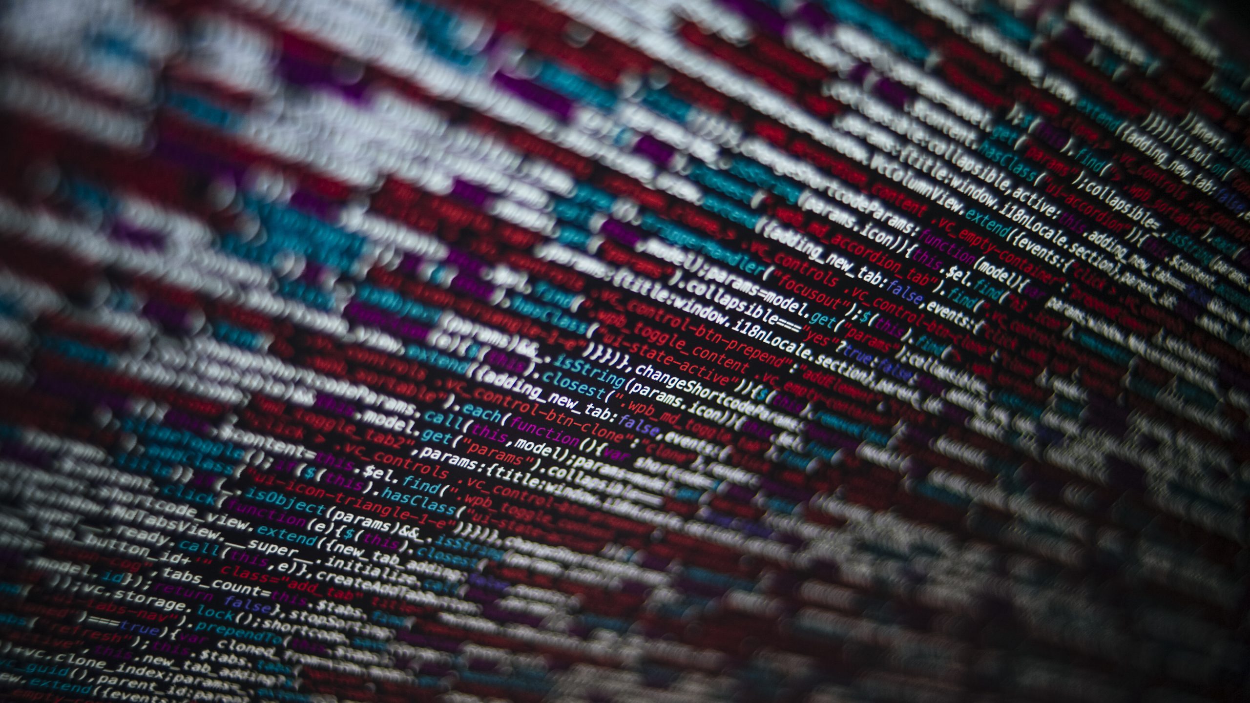 Closeup shot of a screen with HTML JavaScript source code for web page development data